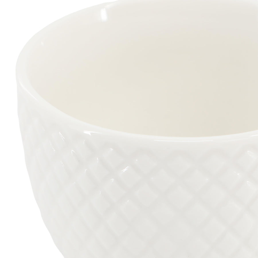 Close up of the diamond pattern texture on the white espresso cup