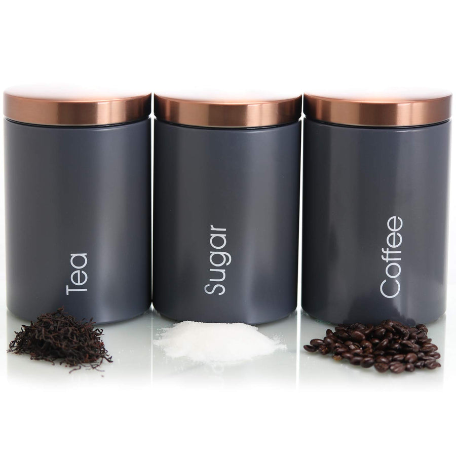 MegaChef Tea, Sugar and Coffee canisters in a row with loose tea, sugar and coffee beans in front of each one