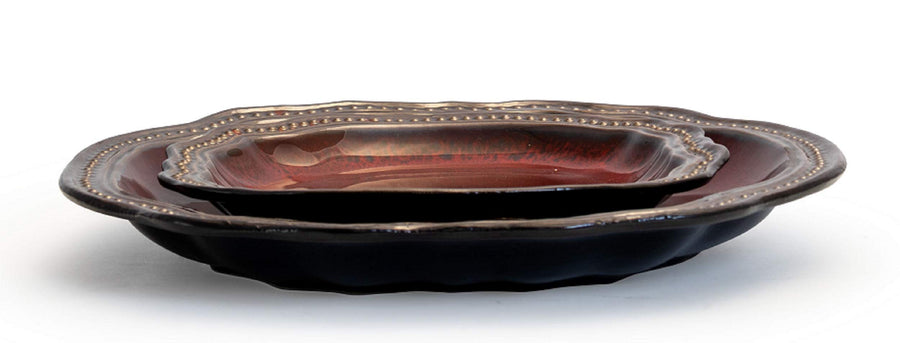 Side view of an Elama Regency red dinner plate and salad plate stacked, showing the scalloped beaded metallic rim