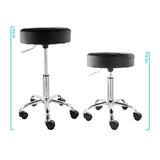 Elama black backless rolling stool shown at its highest and lowest settings to illustrate the adjustable seat height