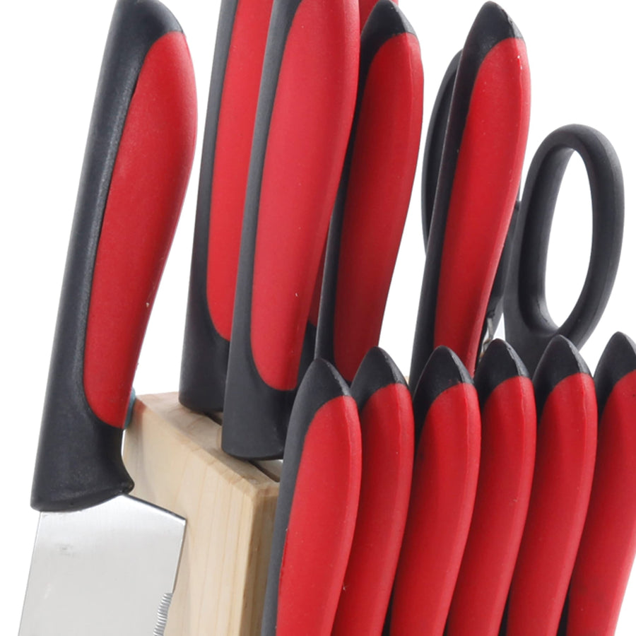 Close up of red and black knife handles and kitchen shears in the wood block