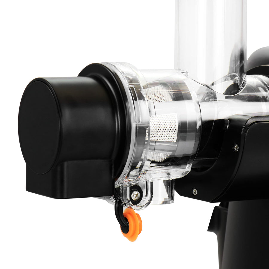 Close-up of the MegaChef slow juicer clear juicing chamber with mesh strainer and orange anti-drip spout cap