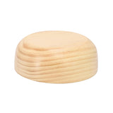 MegaChef 7 inch light acacia wood bowl turned upside down, showing the flat base and natural grain on the side