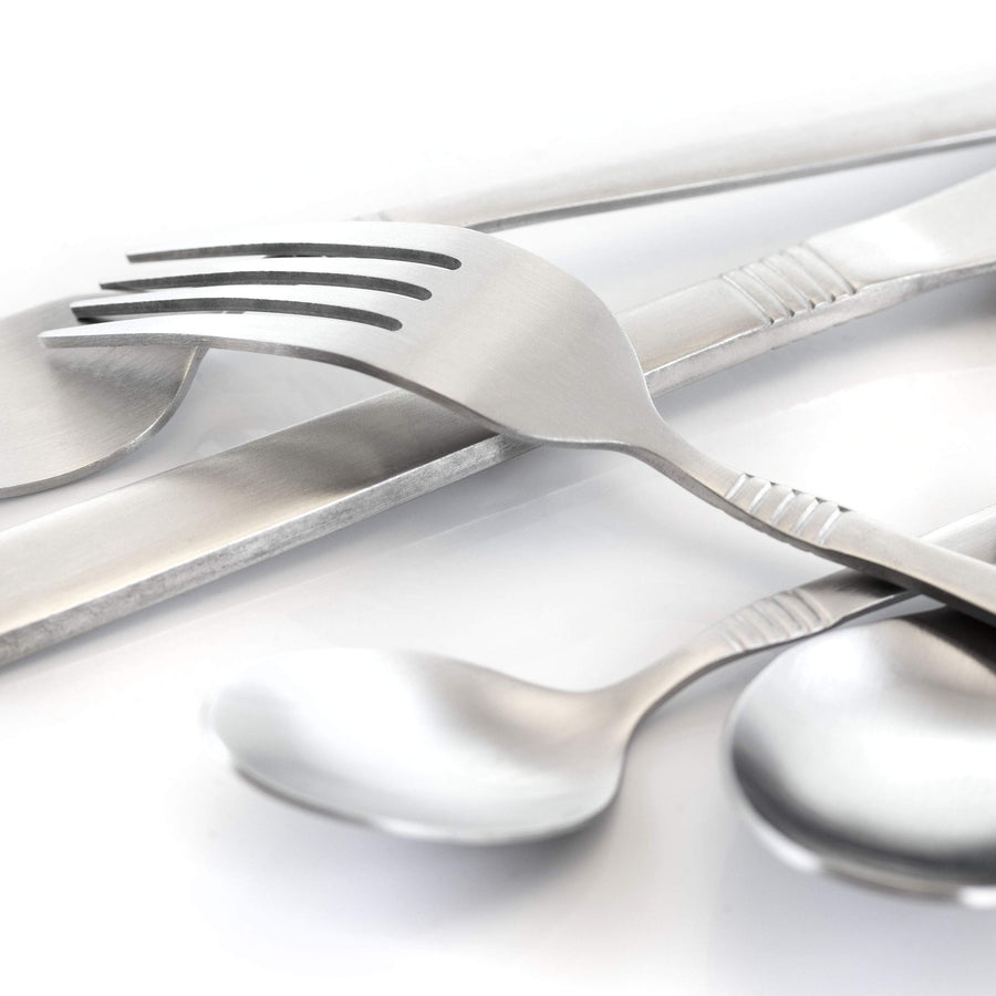 Close up of matte silver flatware handles with engraved line detail