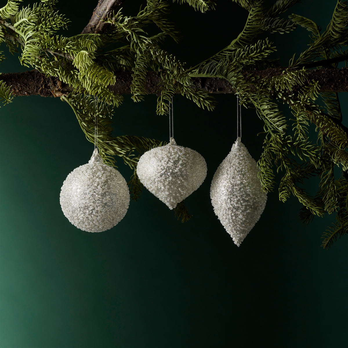 Silver Beaded Glass Christmas Ornaments hanging on a Christmas tree, holiday decor styling idea