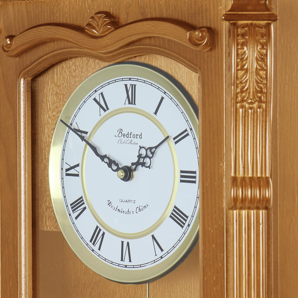 Bedford Clock Collection Golden Oak Chiming Pendulum Wall Clock – Quartz Westminster Chimes, Golden Accents with Swinging Pendulum & Roman Numeral Dial