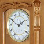 Bedford Clock Collection Golden Oak Chiming Pendulum Wall Clock – Quartz Westminster Chimes, Golden Accents with Swinging Pendulum & Roman Numeral Dial