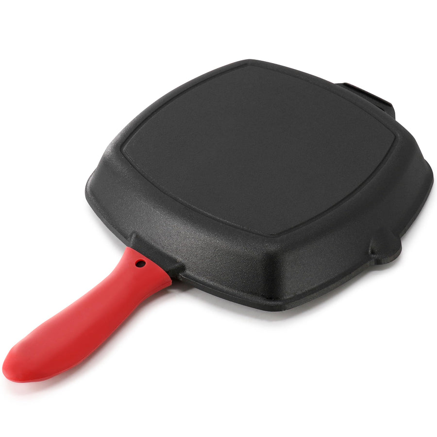 Underside of the square cast iron grill pan with red silicone handle cover