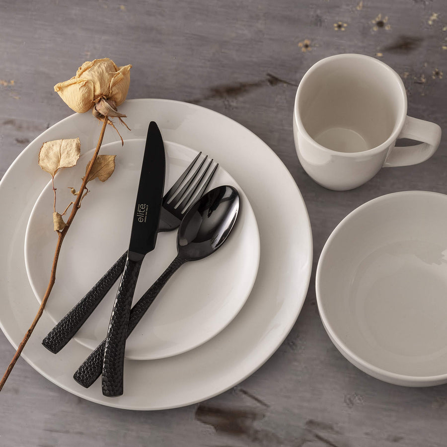 Black hammered flatware on a white dinner plate table setting