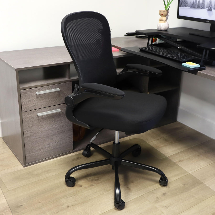 Elama black mid-back mesh office chair, lifestyle at a home office corner desk with a keyboard tray and file drawers