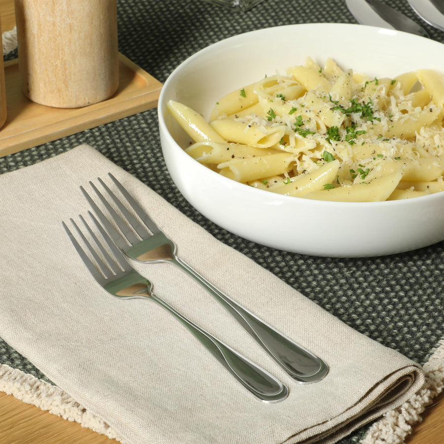 Trillium Plus stainless steel forks beside a pasta bowl