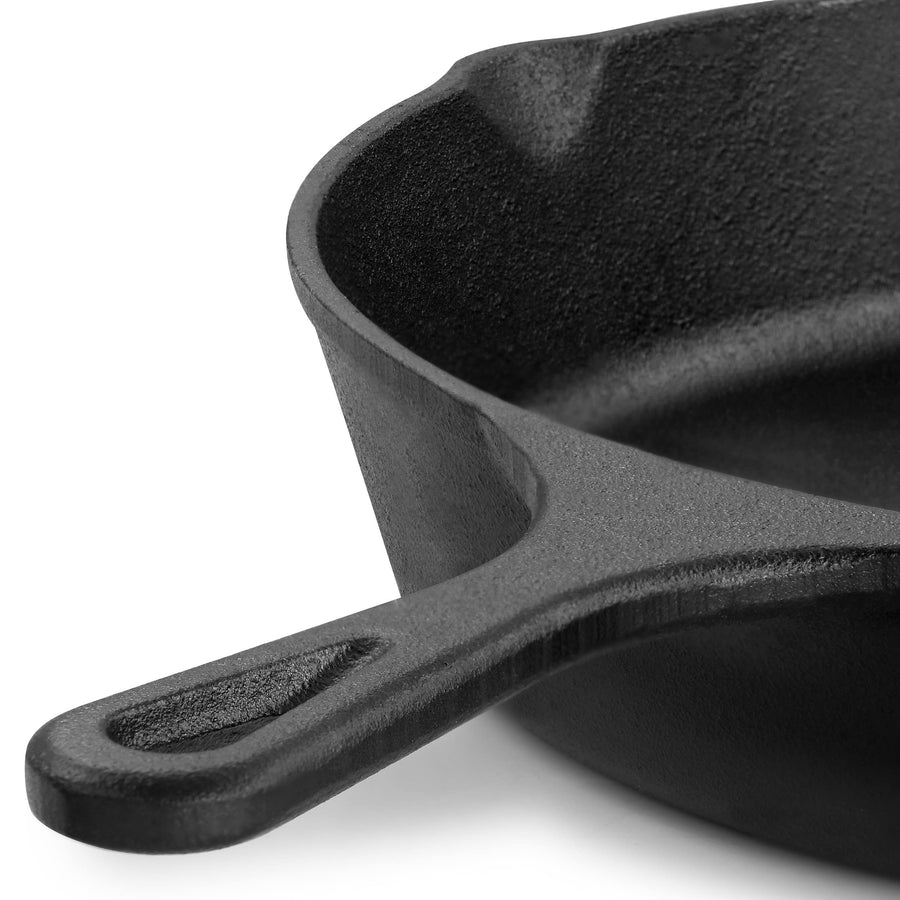 Close up of the cast iron skillet handle with hanging hole and pour spout