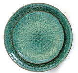 Top view of an Elama Sea Foam Mozaic dessert plate stacked on a dinner plate, embossed mandala and brown trim