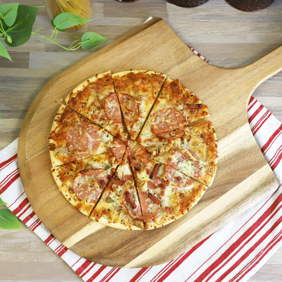 Sliced pizza served on the acacia wood pizza peel