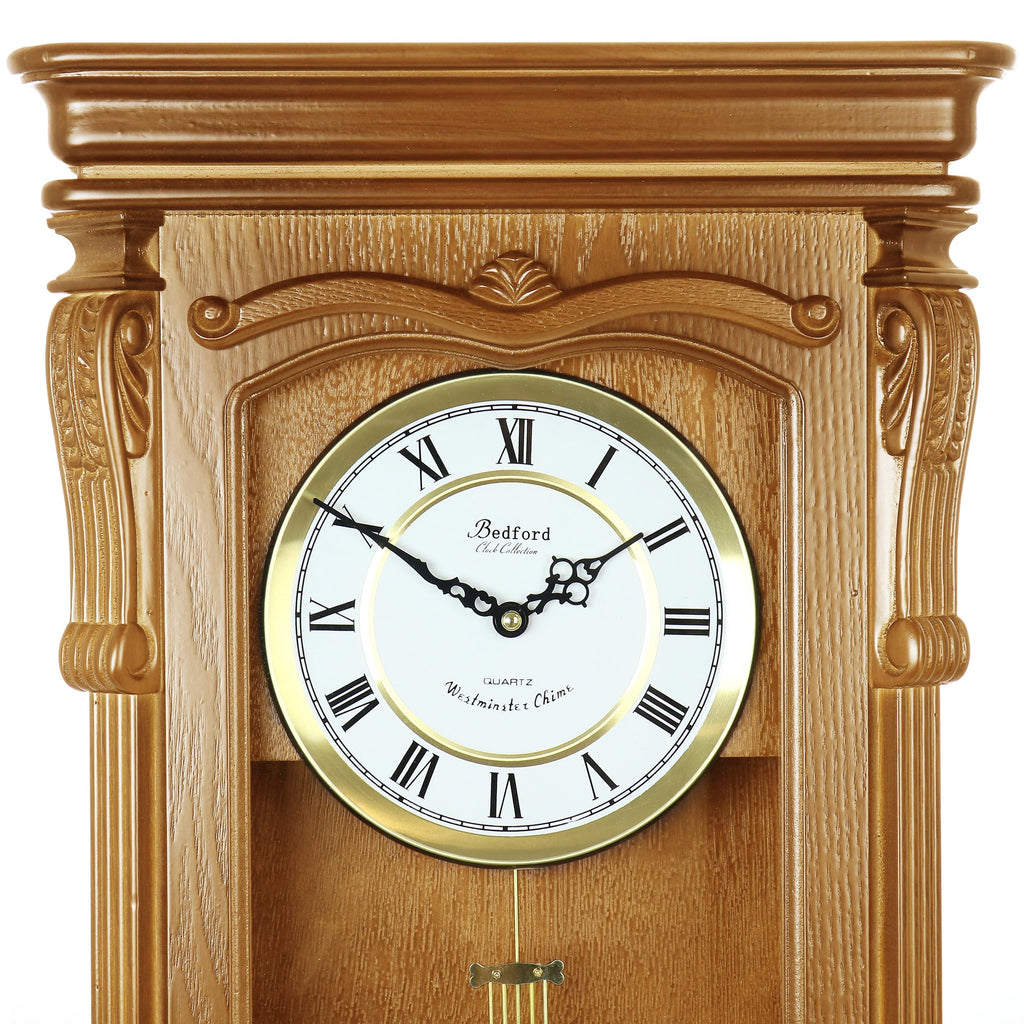 Bedford Clock Collection Golden Oak Chiming Pendulum Wall Clock – Quartz Westminster Chimes, Golden Accents with Swinging Pendulum & Roman Numeral Dial