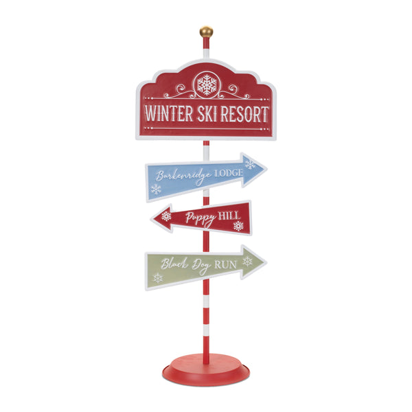 Iron dog ski resort Christmas sign in red, blue, and green with directional signs reading Barkenridge Lodge, Puppy Hill, and Black Dog Run