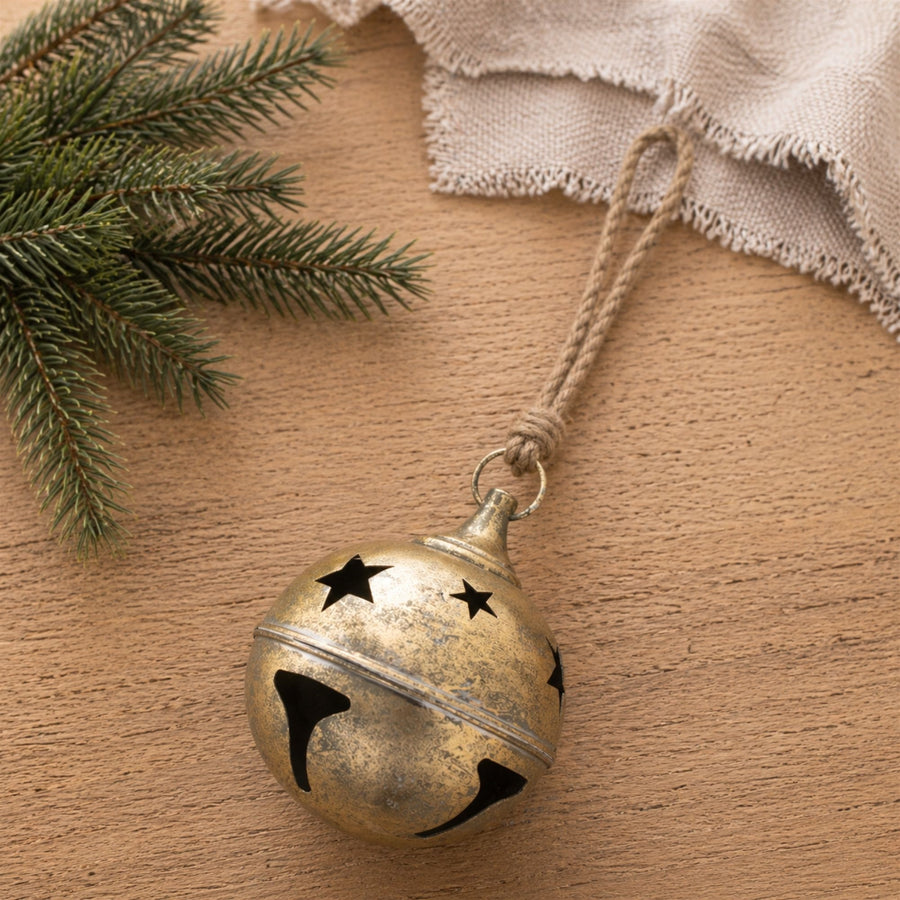 Distressed Gold Metal Sleigh Bell Christmas Ornaments hanging on a Christmas tree, holiday decor styling idea