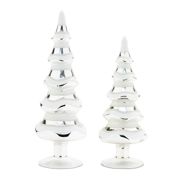 Two white and silver glittered glass pine trees on round bases, 11.5 and 9.5 inches tall