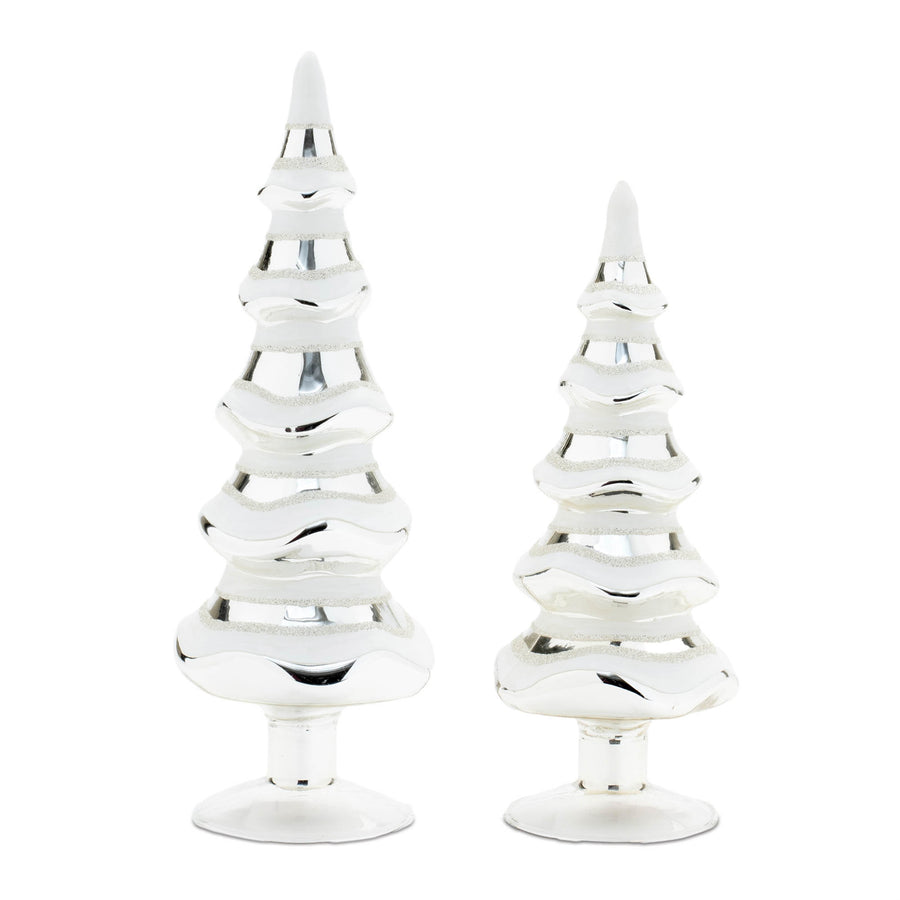 Two white and silver glittered glass pine trees on round bases, 11.5 and 9.5 inches tall