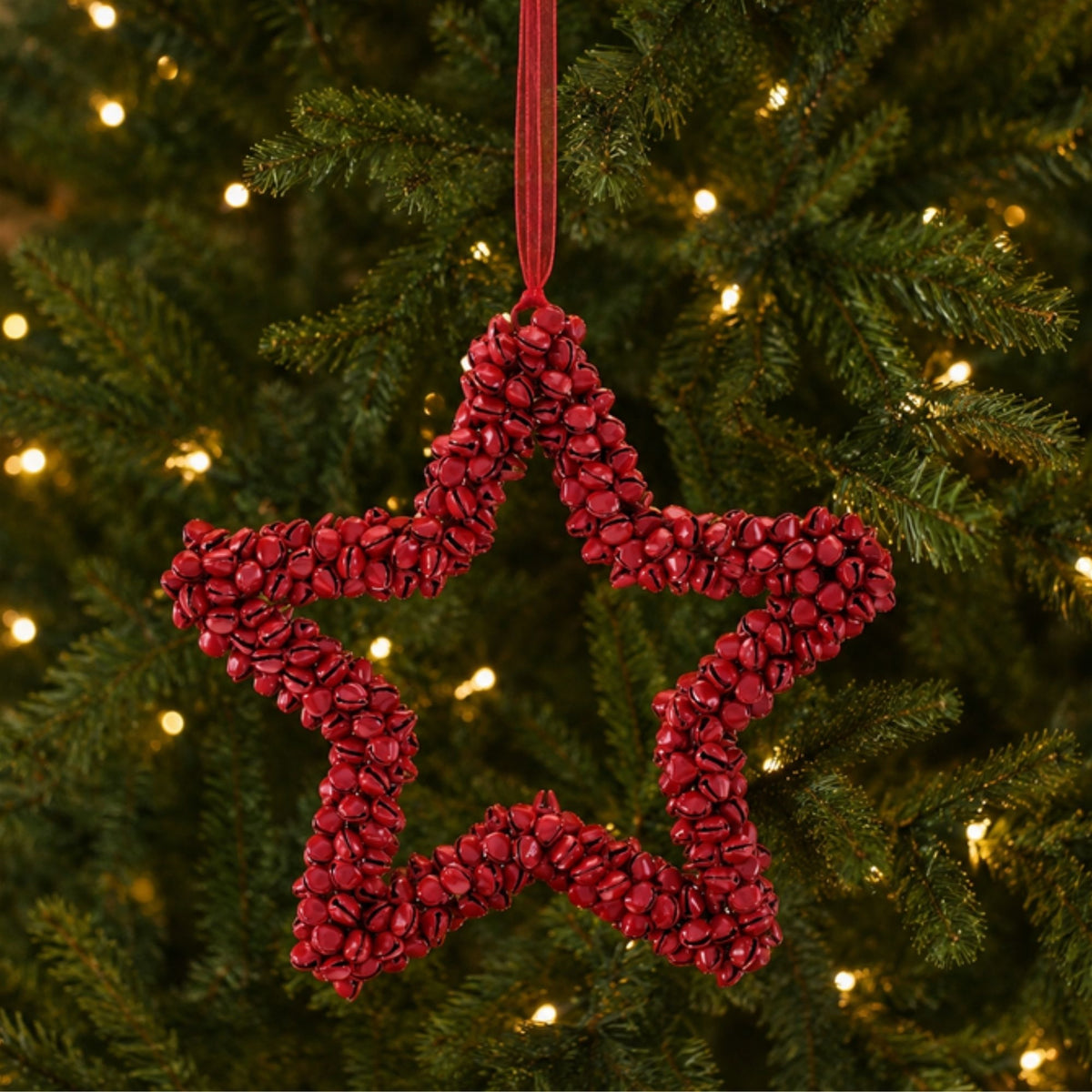 Red Iron Bell Star Christmas Ornaments hanging on a Christmas tree, holiday decor styling idea