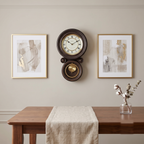 Bedford Clock Collection Contemporary Round Wall Clock with Pendulum – Black Oak & Gold Roman Numeral