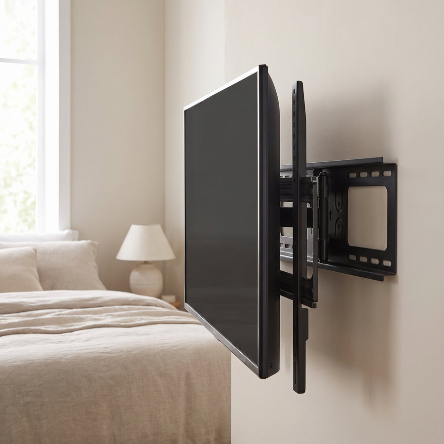 MegaMounts GMW863 mount folded flat behind a TV on a bedroom wall
