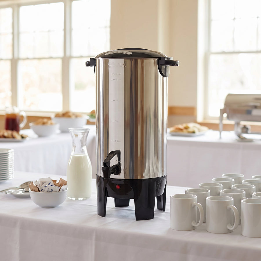 Better Chef IM-155 50 cup coffee urn on a buffet coffee station with a row of mugs