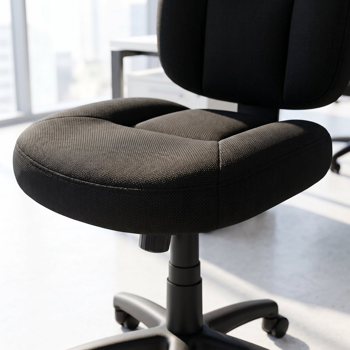 Close-up of an armless black fabric office task chair seat cushion and backrest, compact Elama computer desk chair