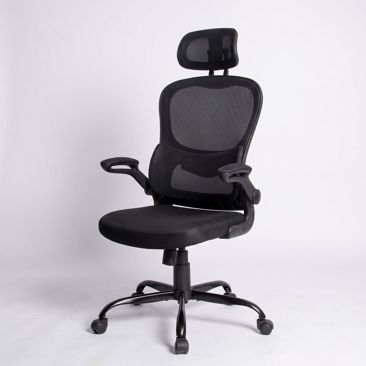 Ergonomic high back mesh office chair with adjustable headrest and flip-up arms, black frame, Elama desk chair on a studio floor