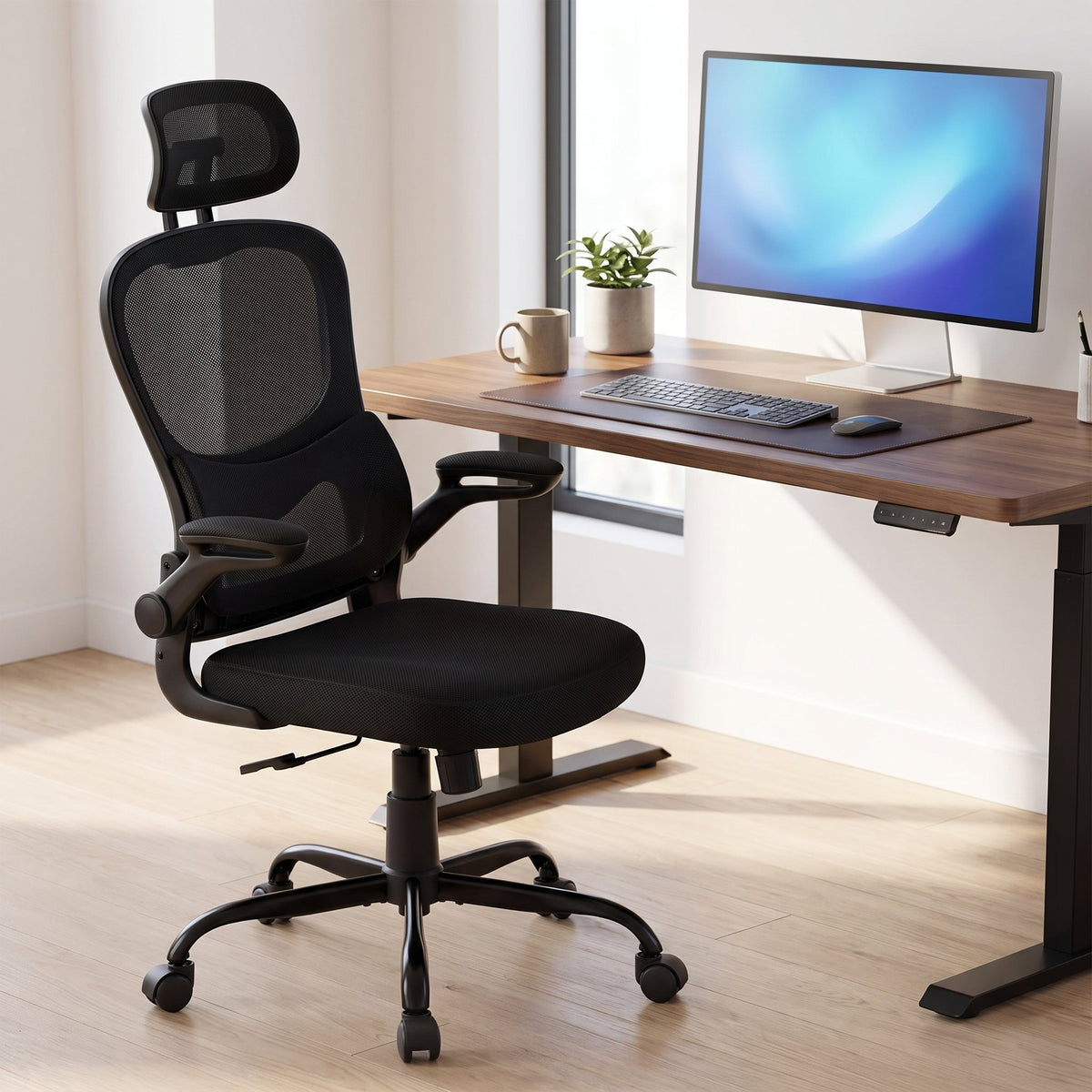 Ergonomic mesh office chair with headrest at a walnut standing desk with monitor and keyboard, Elama black home office chair