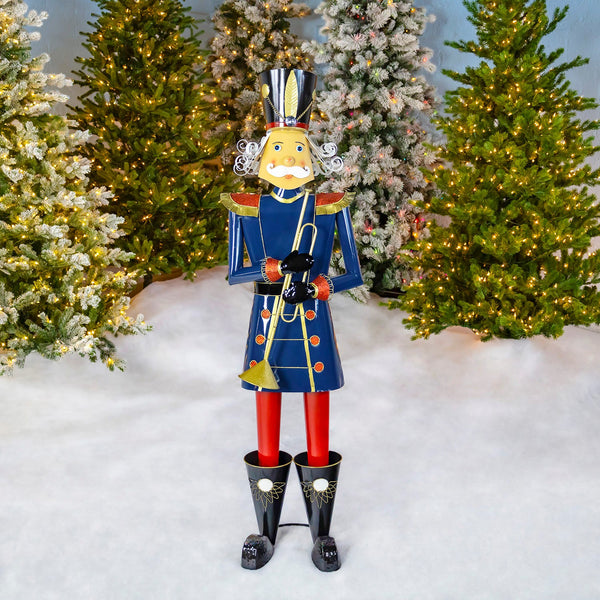 59 inch blue iron Christmas nutcracker playing a trumpet, glossy finish with gold details