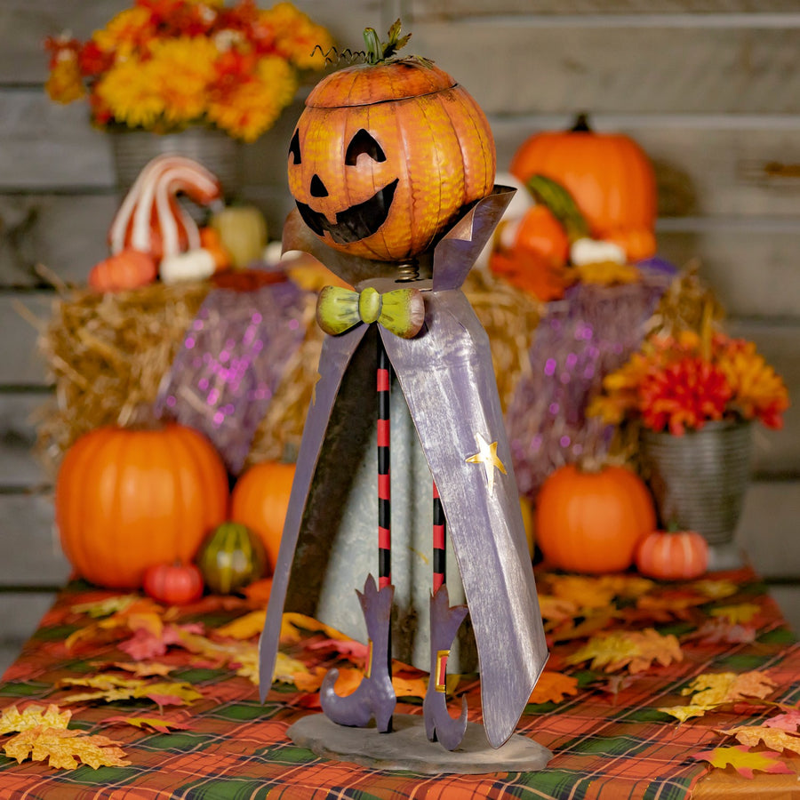 Big head iron pumpkin man figurine with a jack-o-lantern candy dish head and removable lid