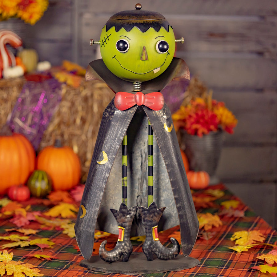 Big head iron Frankenstein monster figurine with a lidded candy dish head on long skinny legs