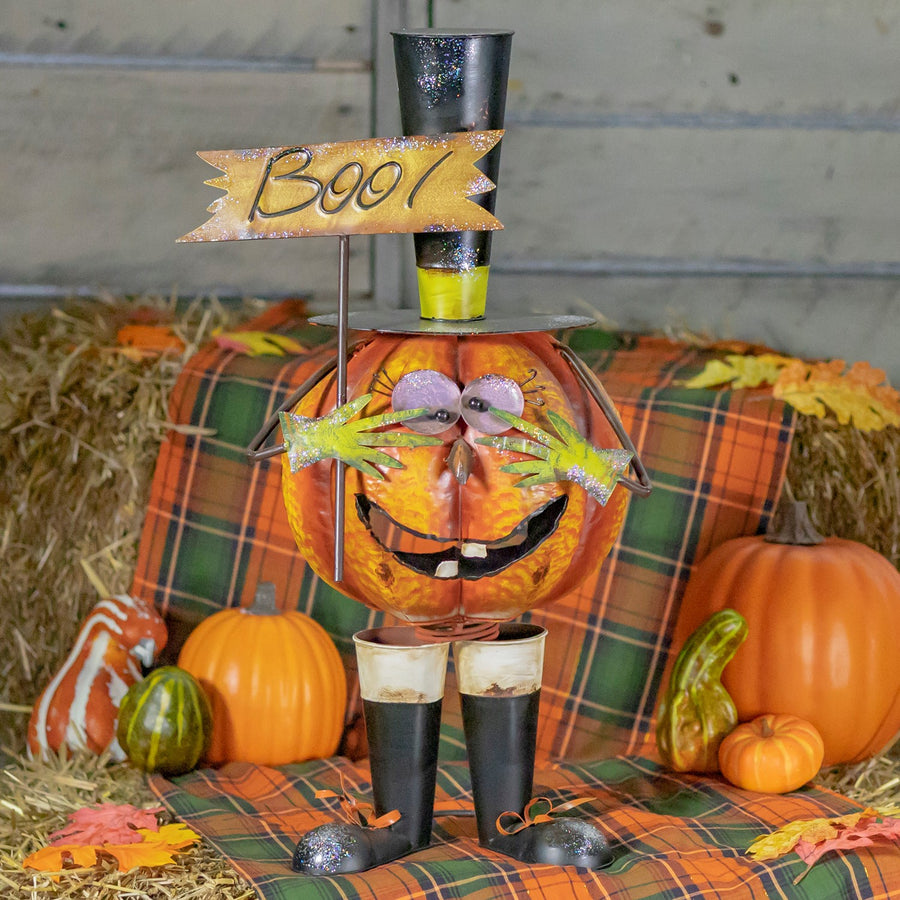 28.25 inch hand painted iron jack-o-lantern in a black top hat with googly eyes holding a BOO sign