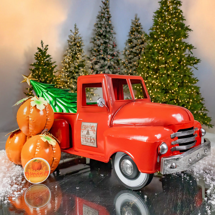 Small iron pickup truck decor in glossy red with a removable pumpkin cluster and Christmas tree