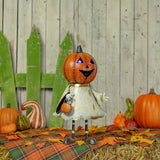 Iron jack-o-lantern ghost figurine in orange and white with gold accents and purple LED lights
