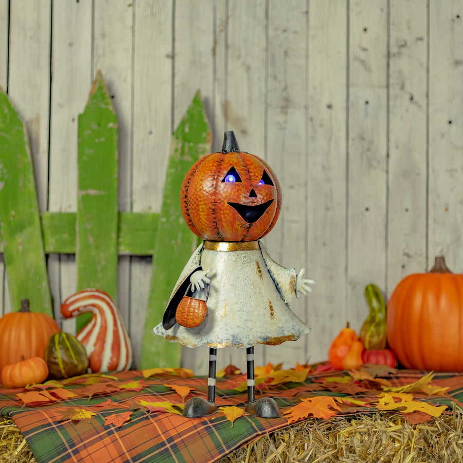 Iron jack-o-lantern ghost figurine in orange and white with gold accents and purple LED lights