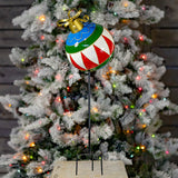Iron Christmas ball ornament garden stake painted blue, green, red, and white with gold trim and bow