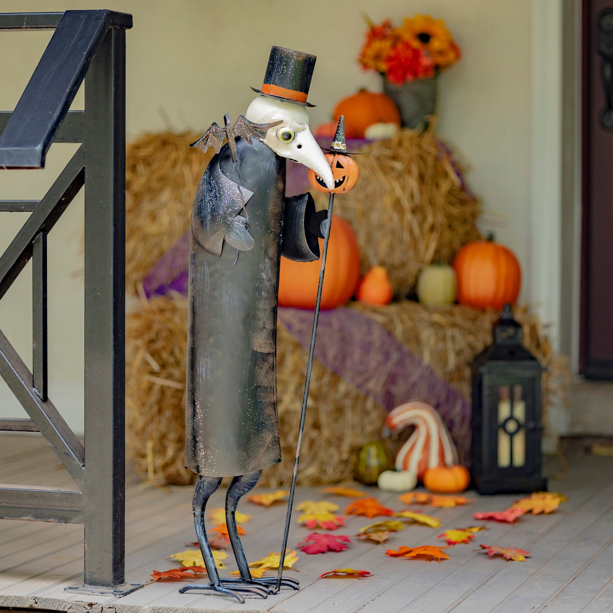 34 inch hand painted iron vulture in a top hat holding a pumpkin cane, black and white distressed finish
