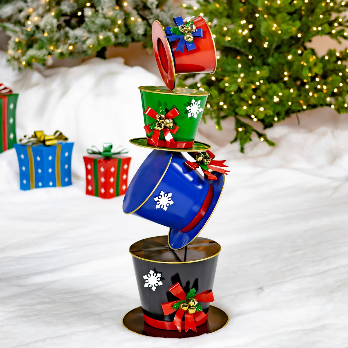 40 inch iron tower of stacked top hats hand painted glossy blue with snowflakes, metal bow, and bells