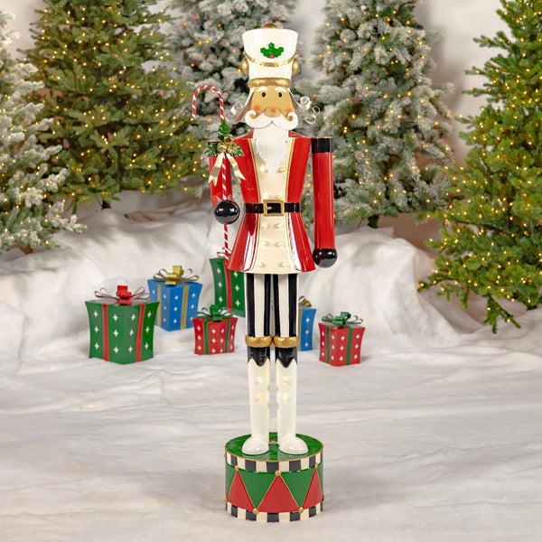 65 inch standing iron nutcracker in a red jacket with a candy cane staff and white LED lights