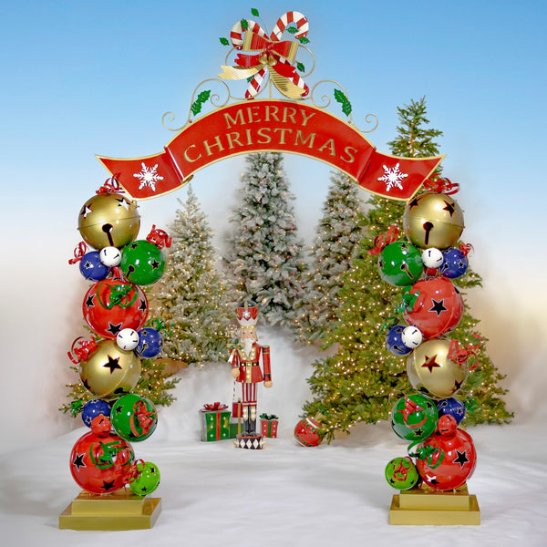 10 ft iron Christmas archway with stacked jingle bell pillars, red MERRY CHRISTMAS banner, and gold bow
