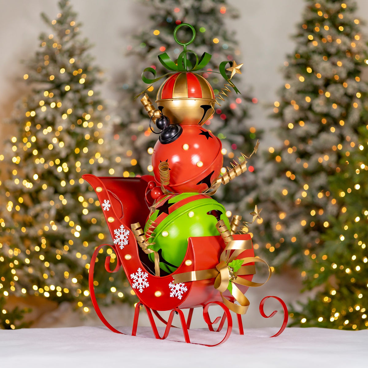 Iron Christmas sleigh filled with giant red, green, and gold jingle bells and LED lights