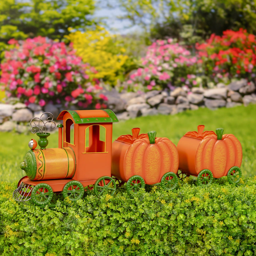 39.5 inch hand painted iron pumpkin train with orange locomotive and two pumpkin carts on a green rail