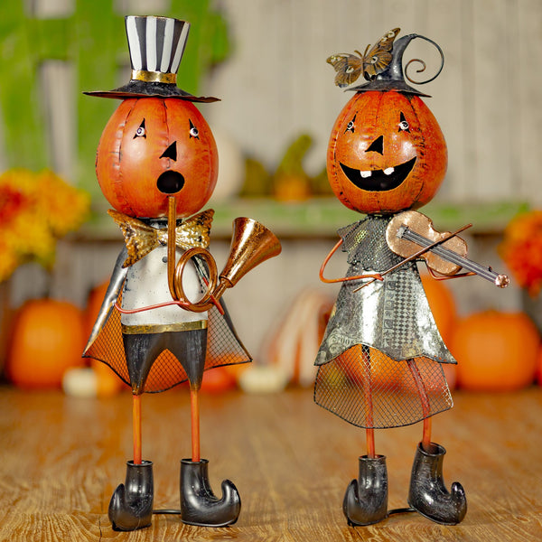 Two hand painted iron jack-o-lantern musicians, a man with a French horn and a lady with a fiddle, orange and black