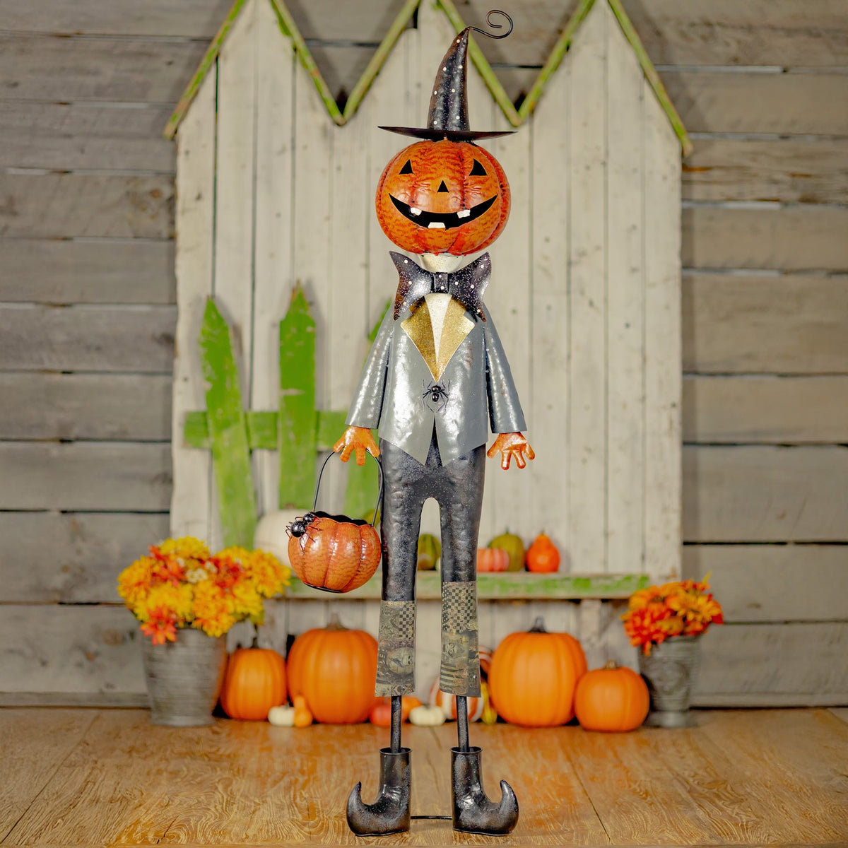 56.5 inch iron jack-o-lantern gentleman with top hat, bow tie, and basket of spiders, distressed black and orange