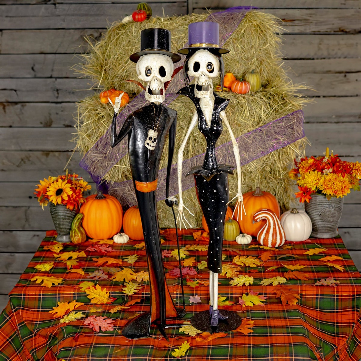 Set of two hand painted iron skeleton figures, a clergyman and a vintage lady, in matte black and white