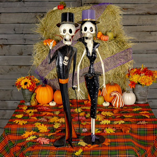 Set of two hand painted iron skeleton figures, a clergyman and a vintage lady, in matte black and white