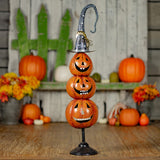 32.75 inch hand painted metal jack-o-lantern totem tower on a stand, orange and black