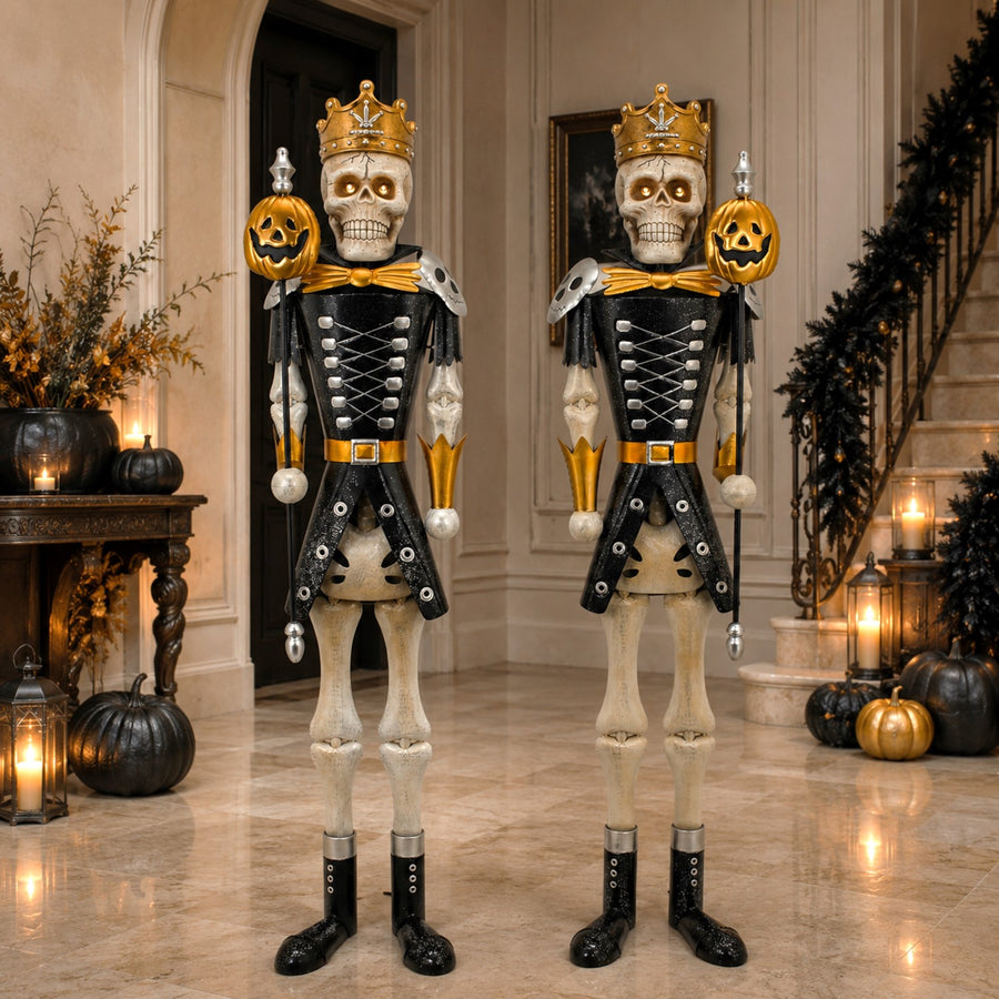 Pair of five foot gold ancient skeleton sentry figures holding pumpkin staffs, distressed gold hand painted finish